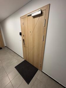 a wooden door in a room with a tile floor at Kaunas City Center Apartment in Kaunas