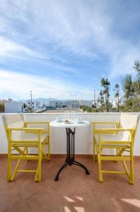 a table and chairs on a balcony with a view at Magic Summer in Agia Anna Naxos +31 photos