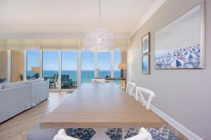 a dining room with a table and a view of the ocean at Phoenix Orange Beach II 2103 in Orange Beach
