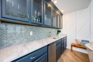 a kitchen with blue cabinets and a counter top at Phoenix Orange Beach II 2103 in Orange Beach