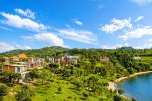 an aerial view of a resort on a hill next to a river at Kaliba Beach - Rutsiro in Rutsiro