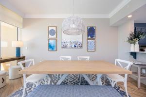 a dining room with a wooden table and chairs at Phoenix Orange Beach II 2103 in Orange Beach +46 photos