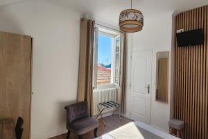 a room with a table and chairs and a window at Hôtel Parc Mazon-Biarritz in Biarritz