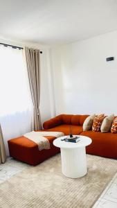 a living room with a couch and a table at Homly Stays in Kisii