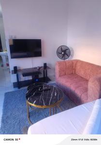 a living room with a couch and a coffee table at Homly Stays in Kisii