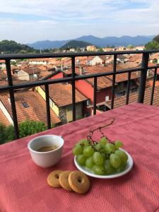 a plate of grapes and cookies on a table with a view at Casa Ilaria in Armeno