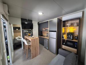 a small room with a kitchen and a living room at SUNNY Rest Nest in Pakoštane