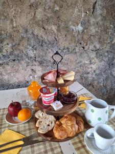 a table with a tray of breakfast foods and coffee at B&B near Lake Como - Close to train & bus - Breakfast included in Valmadrera