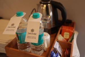 two bottles of water are sitting on a table at Tuli Orchid - A Boutique Eco Resort in Rāmtek