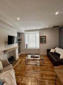a living room with a couch and a coffee table at FRESH Flat in Leek, Staffordshire in Leek