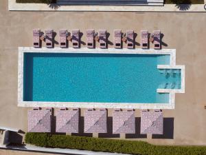 an overhead view of a swimming pool with lounge chairs at Tzanis Resort Skyros in Skiros