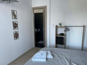 a bedroom with a bed and a door to a bathroom at Vesper Rooms in Skala Prinou +89 photos