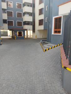 an empty parking lot in front of a building at Kwame Homes in Nakuru