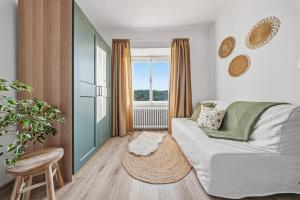 a living room with a white couch and a window at Napajedla in Znojmo +70 photos