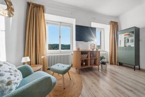 a living room with a blue couch and a tv at Napajedla in Znojmo