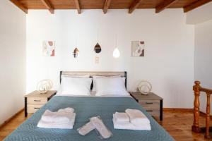 a bedroom with a bed with towels on it at Ariadne de Potie Maisonette - Chania Old Town in Chania