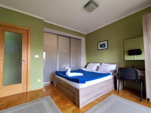 a bedroom with a bed with a swan on it at Apartment Temple in Podgorica