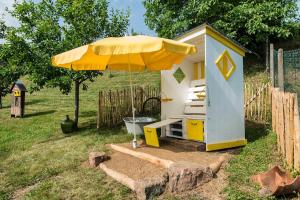 a play house with an umbrella in a yard at FEWO Odenwald in Breuberg