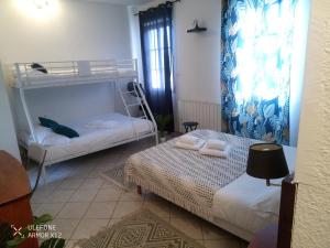 a bedroom with two bunk beds and a lamp at Le Castel d'olmes in Laroque-dʼOlmes