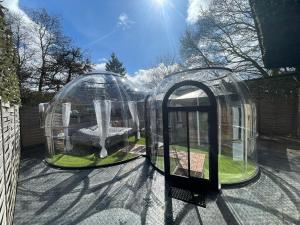 two domed gazebos with a garden in it at Bubble-Hotel Deutschland in Orlenbach