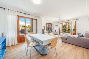 a living room with a table and a couch at Villa Magraner by Sealand Villas in Can Picafort