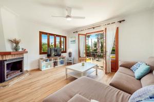 a living room with a couch and a fireplace at Villa Magraner by Sealand Villas in Can Picafort +22 photos