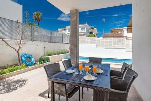 a table and chairs on the balcony of a house at Villa Magraner by Sealand Villas in Can Picafort
