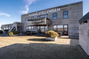 a building with a sign that reads duck hotel at Dock Hotel Stellendam in Stellendam