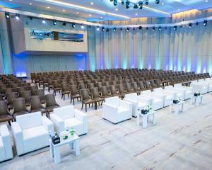 an empty hall with rows of chairs and tables at Babylon Rotana Hotel in Baghdād +115 photos