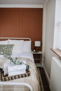 a bedroom with a bed with a tray of towels on it at Room 2 at The Firs in Backwell