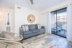 a living room with a couch and a balcony at Lei Lani 108 condo in Orange Beach