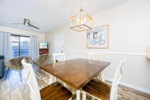 a dining room with a wooden table and chairs at Lei Lani 108 condo in Orange Beach