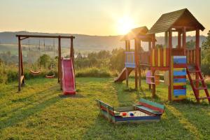 a group of playground equipment in a field at Góralski Dom - Osada Gawlaki in Zakopane