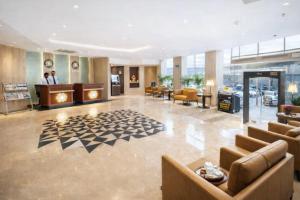 a lobby of a hotel with couches and a waiting room at OPO Premier Ro'yal Delhi Airport - FREE Airport Pickup Or Drop in New Delhi