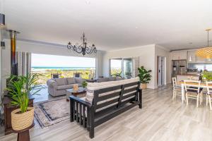 a living room with a couch and a table at Whales Rest in Pearly Beach