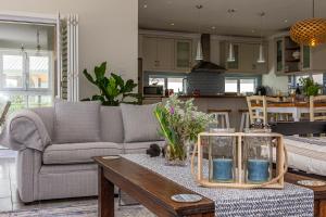 a living room with a couch and a table at Whales Rest in Pearly Beach +47 photos