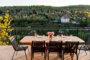 a wooden table and chairs on a deck at Napajedla in Znojmo