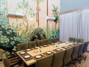 a conference room with a long table and chairs at City Center Suites in Bhatinda