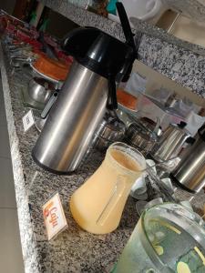 a counter top with a coffee pot and a mixer at Hotel CANTO DA SERRA in Caldas Novas
