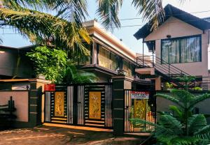 a house with a gate in front of it at JFZ Homestay in Kāsarkod +19 photos