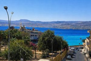 a view of a city with the ocean in the background at Nice Apartment with Sea View in Aqaba