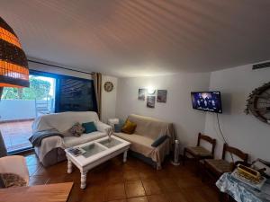 a living room with a couch and a table at Perlazul in Peniscola