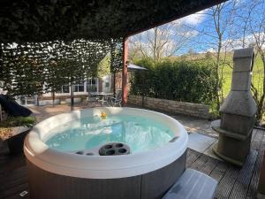 a jacuzzi tub in a yard with a patio at Bubble-Hotel Deutschland in Orlenbach
