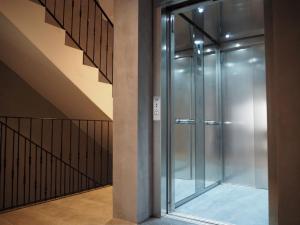 a glass elevator in a building with a staircase at Quaint Boutique Hotel Xewkija in Xewkija +23 photos