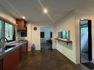 a kitchen with a sink and a counter at Nutmeg Cottage SIARGAO 2BR exclusive whole house in General Luna