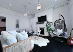 a living room with a couch and a fireplace at Central spacious town house in Exeter