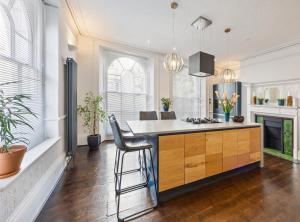 a kitchen with a island in the middle of a room at Central spacious town house in Exeter