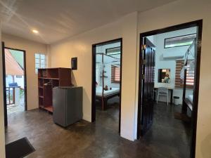 a kitchen with a refrigerator and a dining room at Nutmeg Cottage SIARGAO 2BR exclusive whole house in General Luna