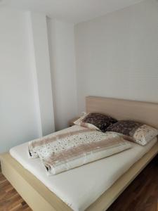 a bed with two pillows on it in a room at Oliver apartmán 6 in Štrbské Pleso