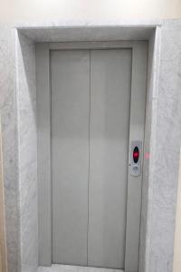 a door with a red light in a white wall at Nice Apartment with Sea View in Aqaba
